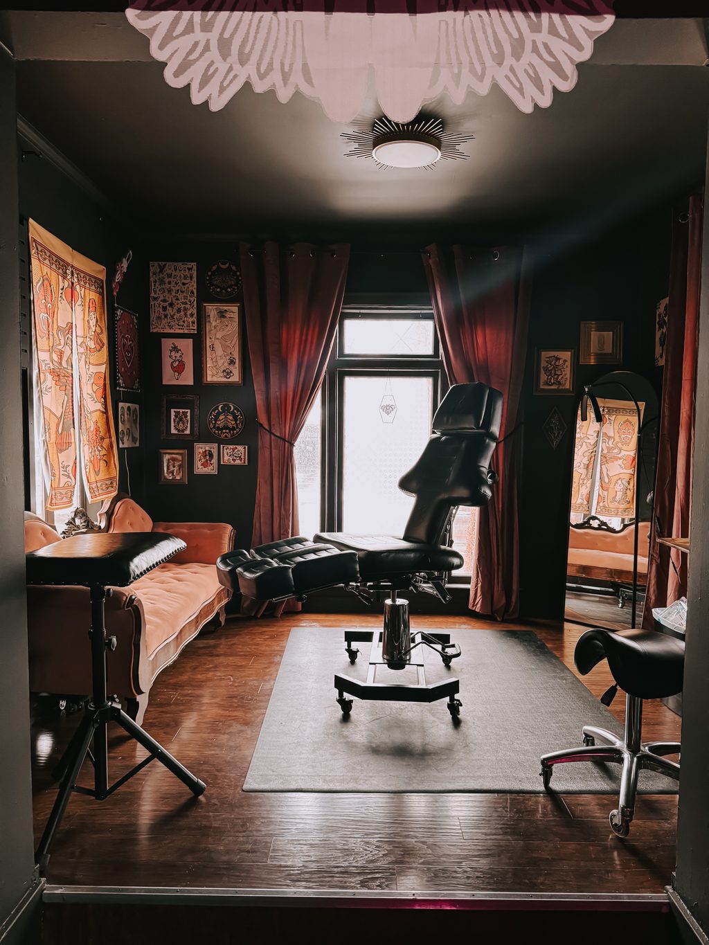 A private tattoo room at Old Friends Tattoo with a velvet sofa.